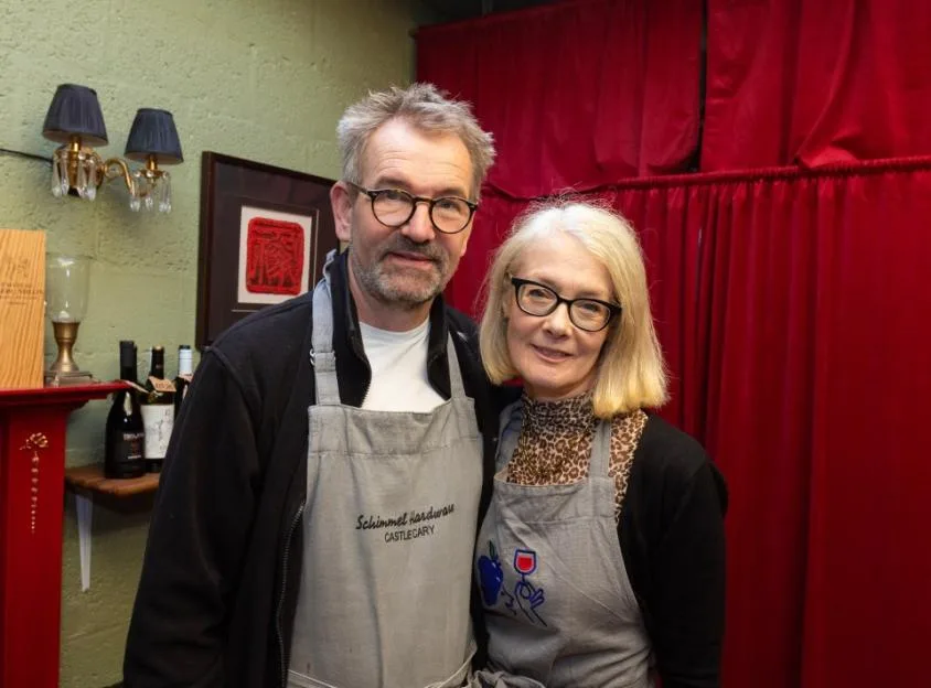 Jan Schimmel and Caroline Sharley in matching grey aprons.