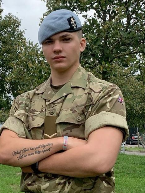 Harry Clark in military uniform with arms crossed.