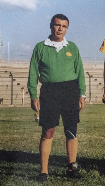 Referee Nando Di Matteo in uniform on a field.