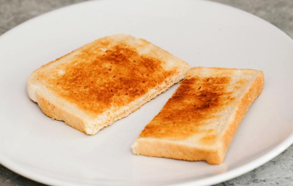 Two slices of lightly toasted white bread on a plate.