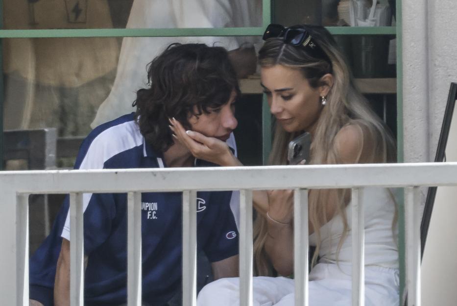 Barry Keoghan and a mystery blonde woman intimately touching faces.