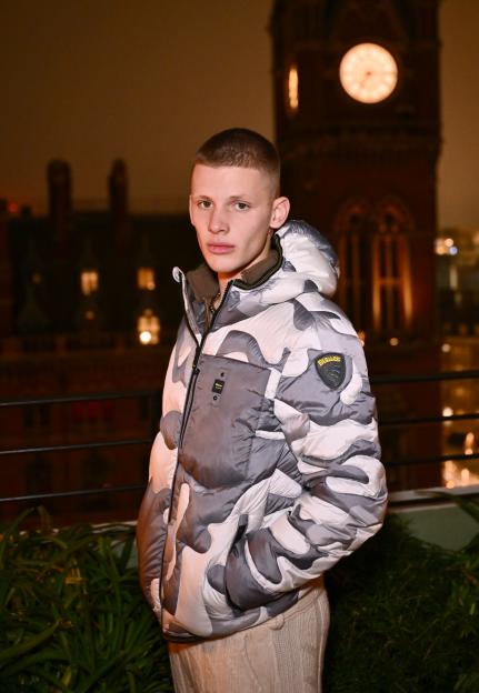 Freddy Brazier wearing a gray and white camouflage padded jacket.