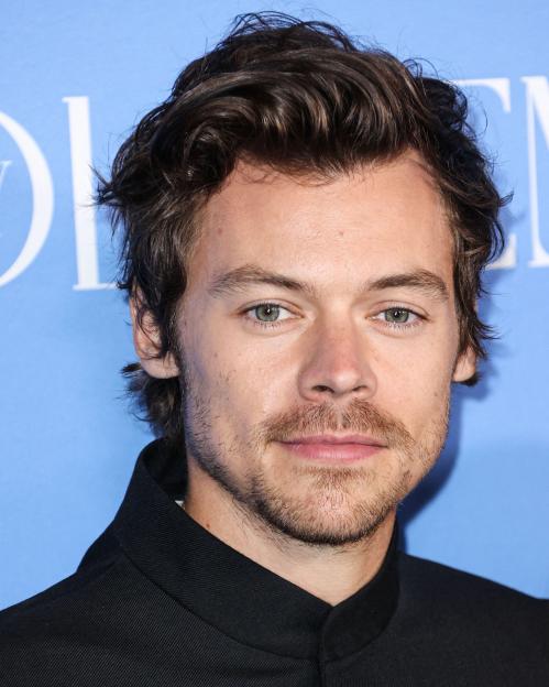 Harry Styles in a black Gucci suit.