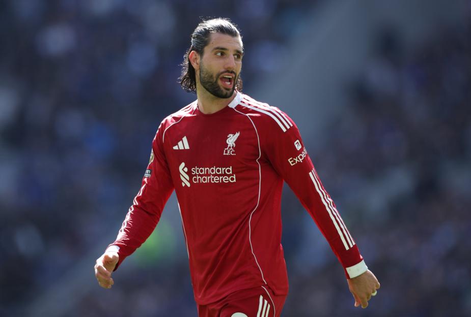 Liverpool player Kostas Tsimikas in a red jersey looking to the right.