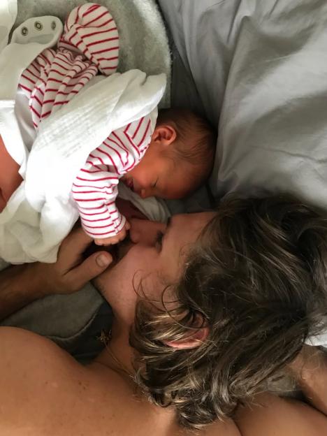 Misse Beqiri next to her newborn baby.