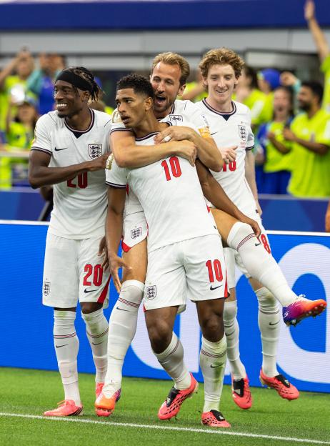 Jude Bellingham celebrating his goal with teammates Harry Kane, Anthony Gordon, and Noni Madueke.
