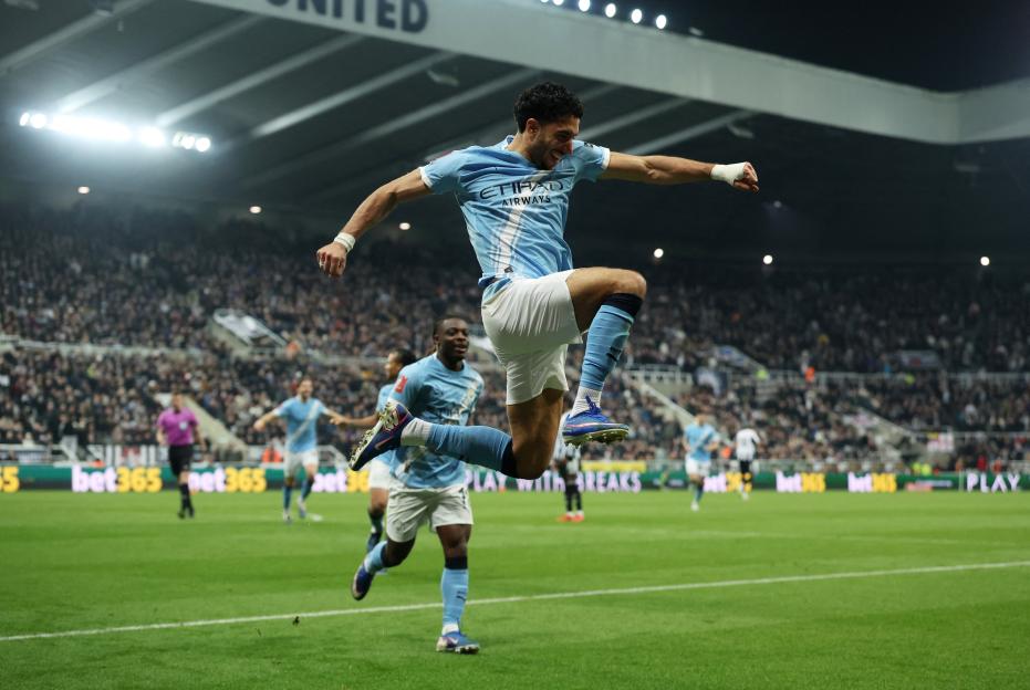 Manchester City's Omar Marmoush celebrates scoring their second goal with Manchester City's Jeremy Doku.