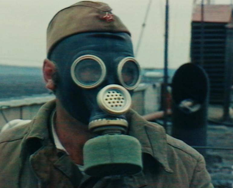 A liquidator wearing a respirator at the Chernobyl disaster site.