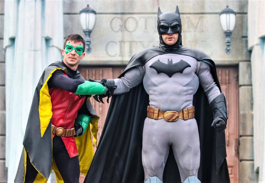 Batman and Robin in front of a Gotham City Hall building.