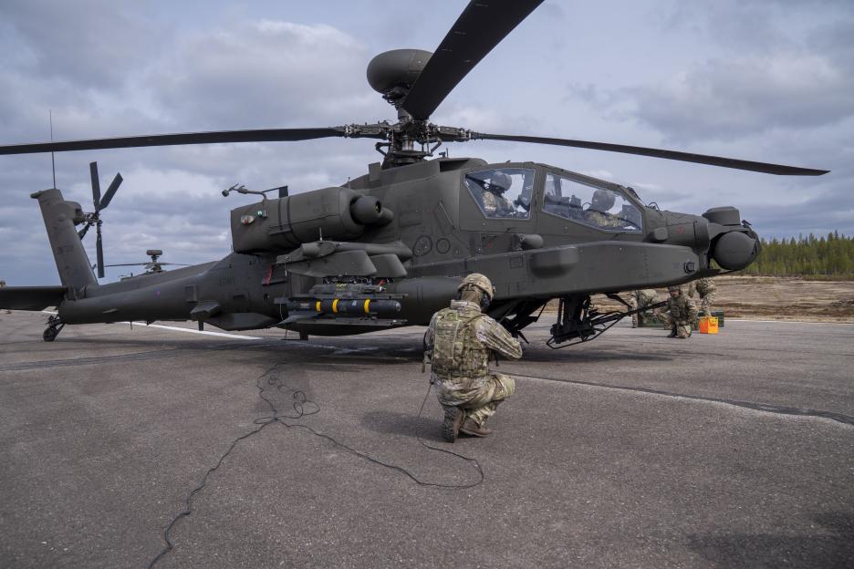 A British Army soldier loading a Hellfire missile onto an Apache helicopter during Exercise Northern Strike.