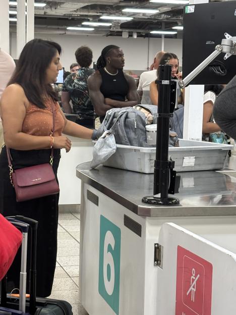 People at an airport security checkpoint.