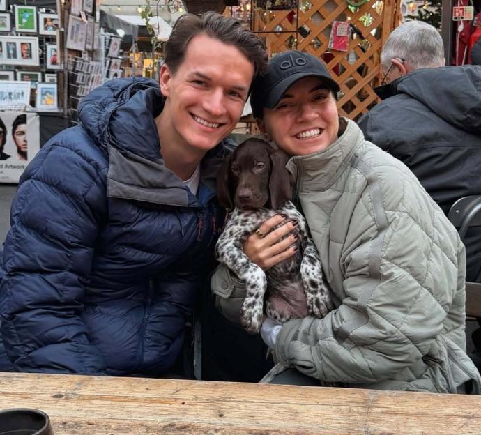 Zoe Ellen Rae with a new dog in her arms.