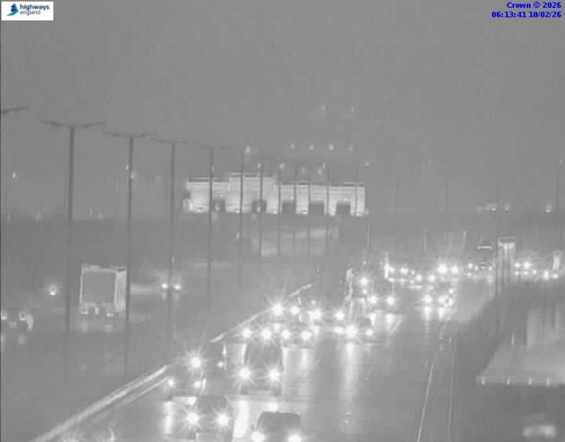 Nighttime traffic on a highway, with car headlights visible.