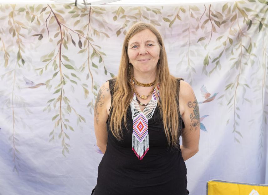 Lilavati, a jewelry seller, wearing an elaborate beaded necklace.