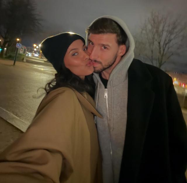Maya Jama and Ruben Dias posing for a selfie at night.