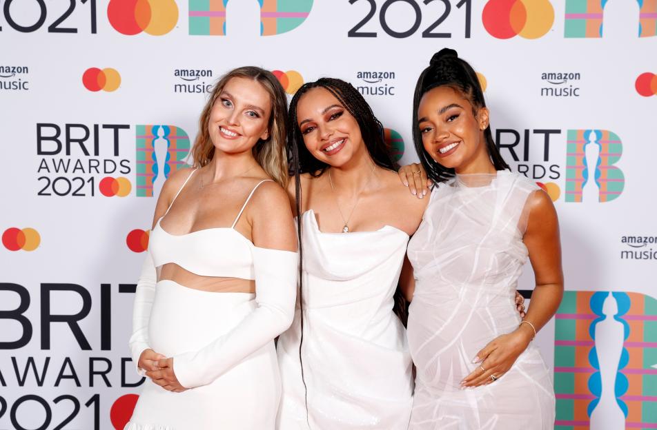 Perrie Edwards, Jade Thirlwall and Leigh-Anne Pinnock of Little Mix posing in white dresses at the BRIT Awards 2021.