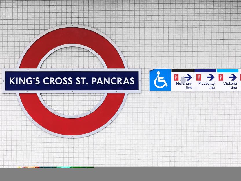 The King's Cross St. Pancras underground station sign, including an accessibility symbol and directions for the Northern, Piccadilly, and Victoria lines.