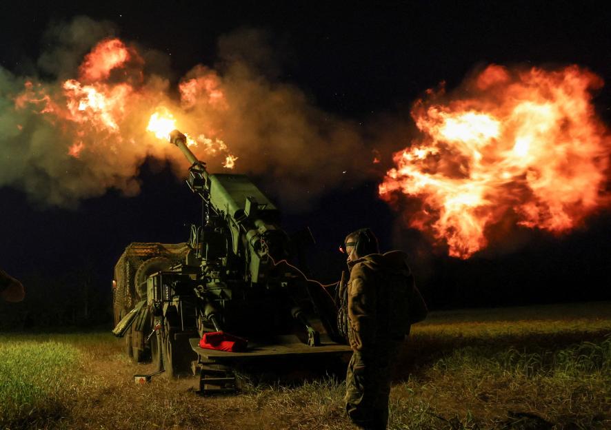 Ukrainian servicemen fire a self-propelled howitzer toward Russian positions on a frontline in Donetsk region