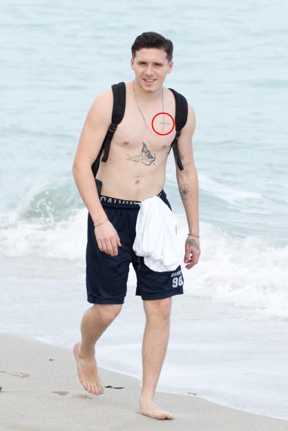 Brooklyn Beckham displaying his tattoos and physique on a Miami beach.