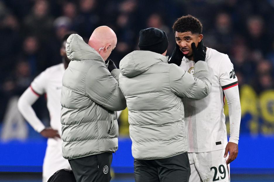 Chelsea FC's Malo Gusto being attended to by team staff during the UEFA Champions League match against Atalanta BC.