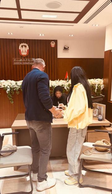 Katie Price and Lee Andrews signing their wedding documents at the Judicial Department in Dubai.