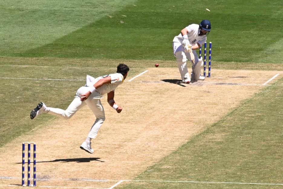 A bowler pitches the ball towards a batsman during a cricket match.