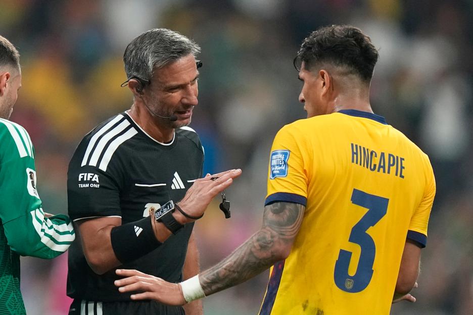 Referee Slavko Vincic talks to Ecuador's Piero Hincapie.