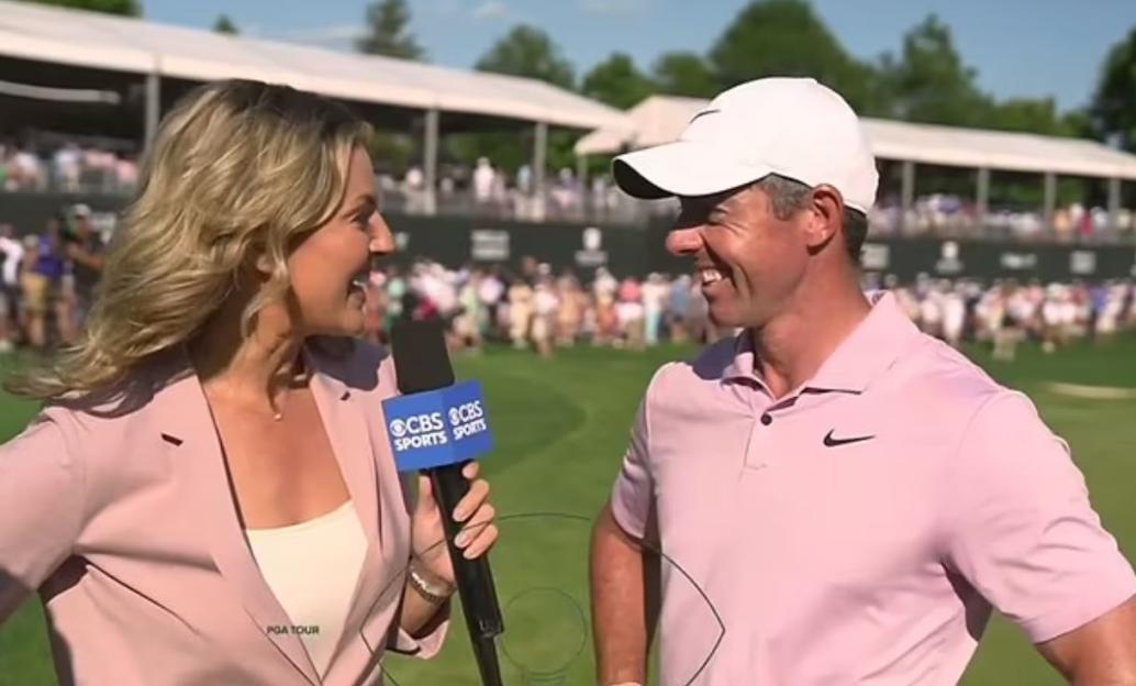 Rory McIlroy and Amanda Balionis smiling during an interview.