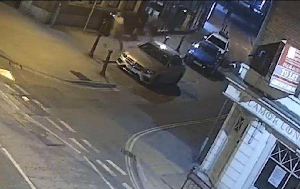 CCTV footage of a person being stabbed on a street at night.