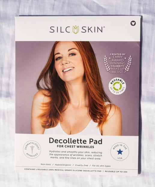 Packaging for SilcSkin Decollete Pads for chest wrinkles, featuring a smiling woman with red hair on the front.