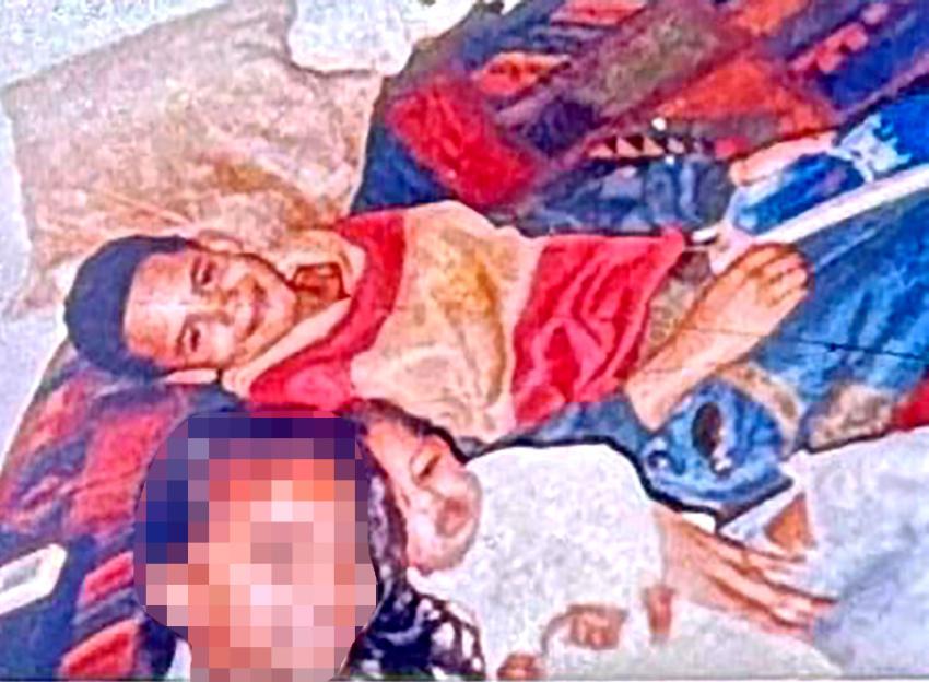 Painting of two children, one smiling, the other sleeping, on a colorful blanket.