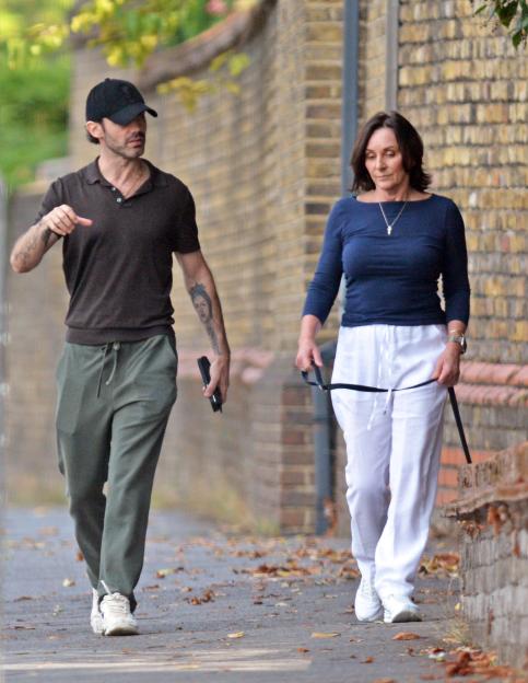 Shirley Ballas and Giuseppe Nonnis walking together in a South London park.