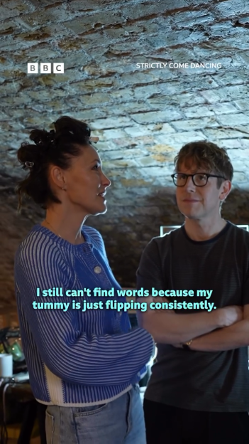 A woman in a blue and white striped top talking to a man in glasses, with the caption "I still can't find words because my tummy is just flipping consistently."