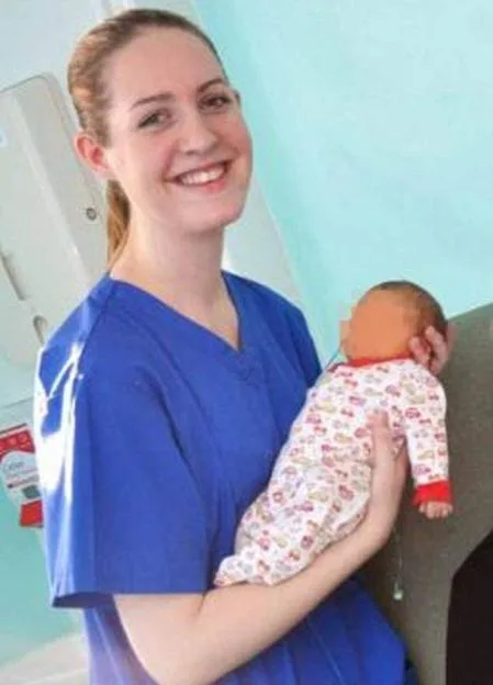 Nurse Lucy Letby holding a baby whose face is blurred out.