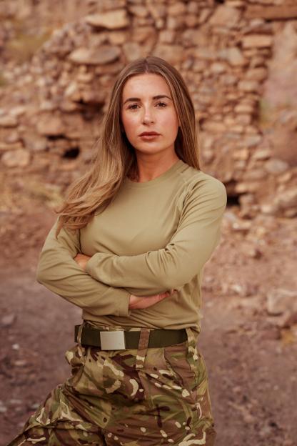 Dani Dyer wearing a uniform with arms crossed.