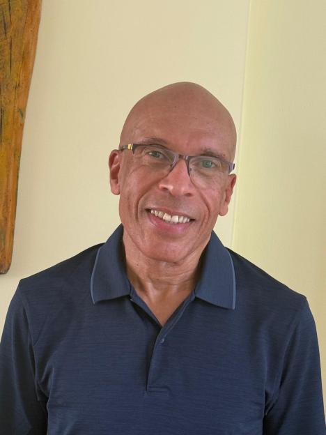 Desmond Reid, a 67-year-old man, smiling at the camera.