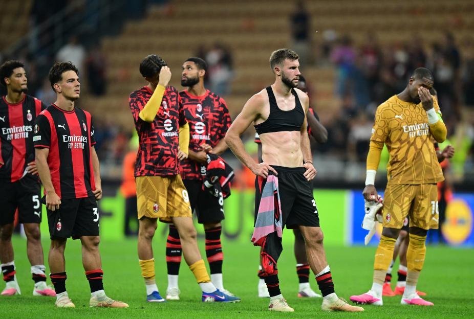 AC Milan's Strahinja Pavlovic and teammates look dejected after the UEFA Europa League match.