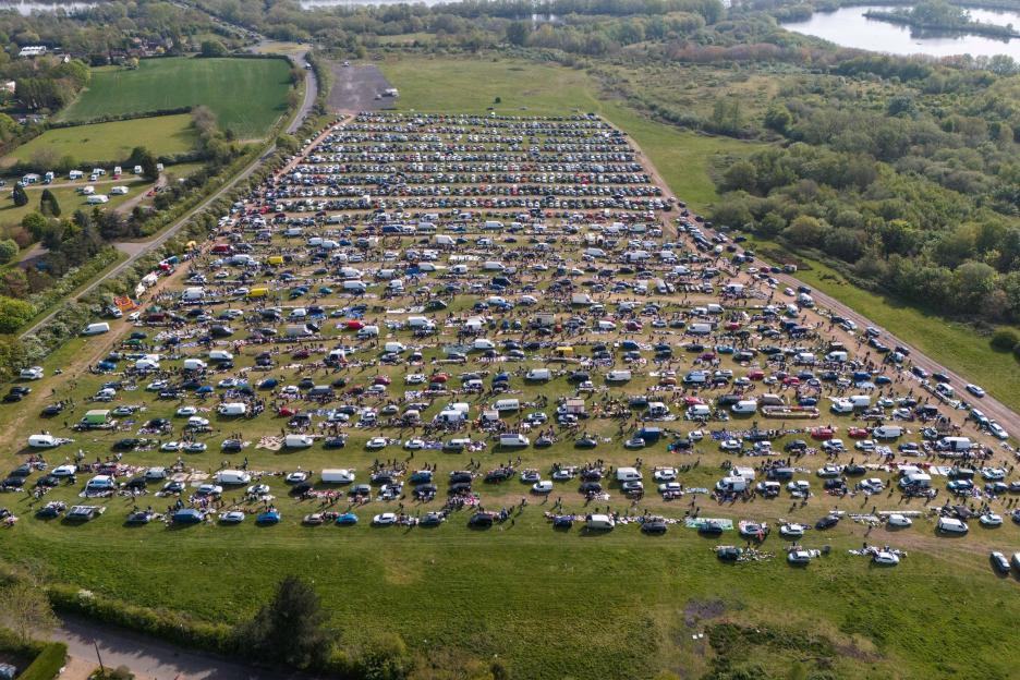 Aerial view of a large car boot sale (Eboot) in a field in Lea Marston, Warwickshire, with rows of cars and people selling items.