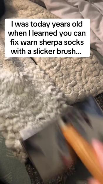 A person brushing a white sherpa material with a slicker brush, with the text overlay "I was today years old when I learned you can fix worn sherpa socks with a slicker brush...".