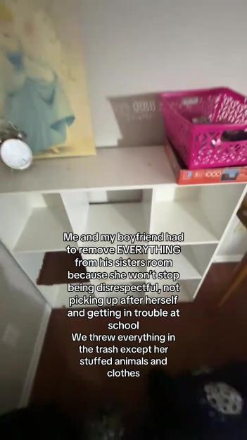 White shelves in a room with a pink basket.