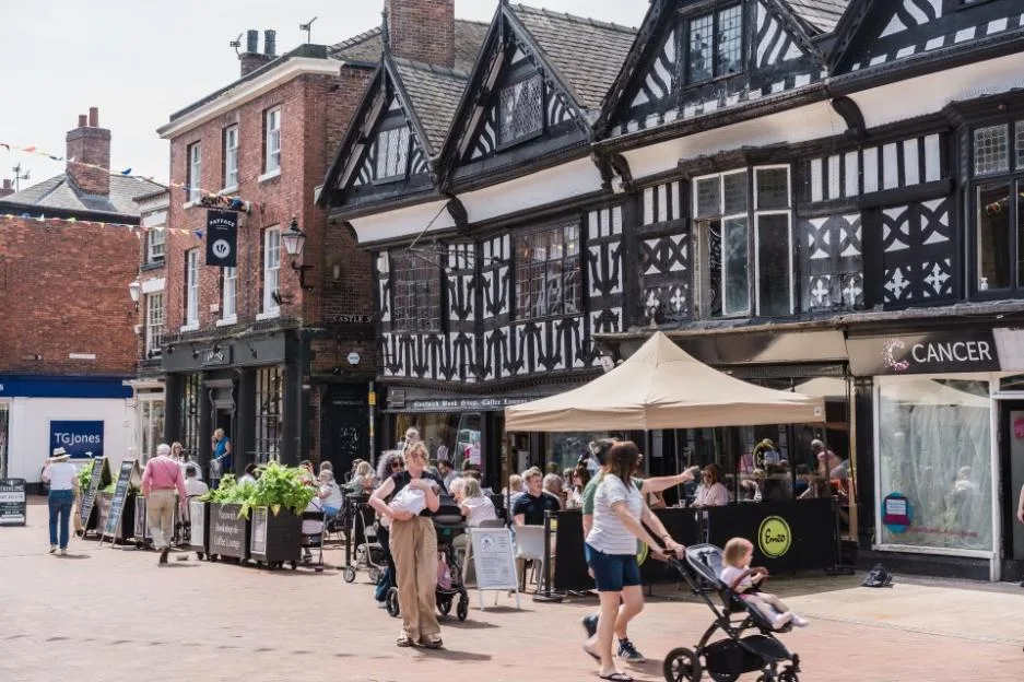People walk past an Enzo cafe on the high street.