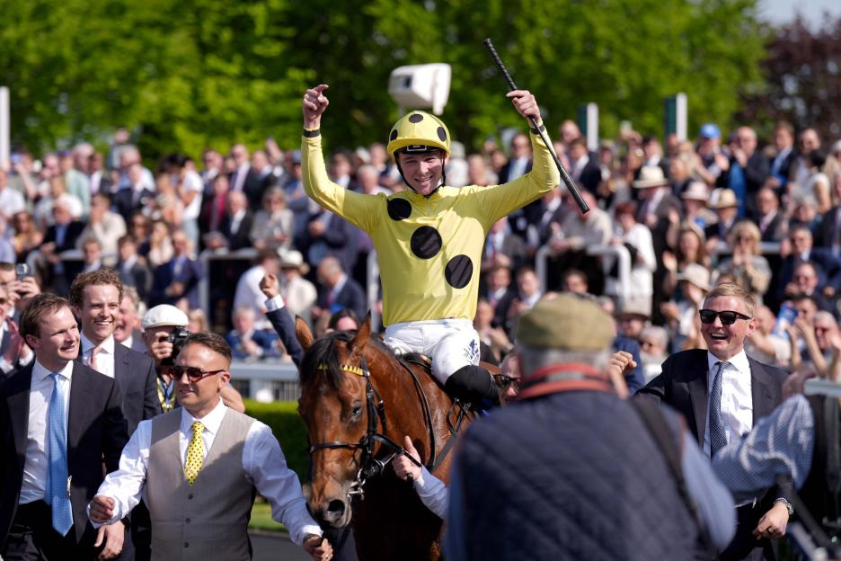 Jockey Billy Loughnane raising his arms in victory on Bow Echo after winning the Betfred 2000 Guineas Stakes.