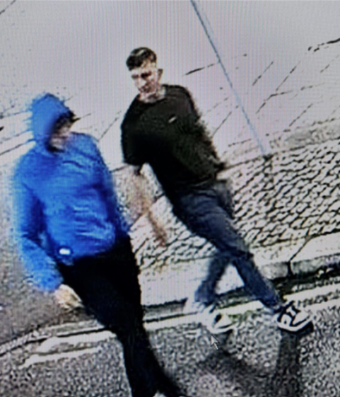 CCTV image of two men, one wearing a blue hoodie and the other wearing a dark shirt.