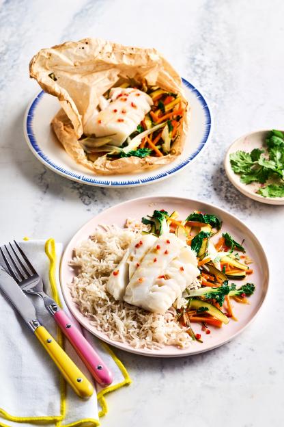 Baked fish and vegetables in parchment, and a plated portion with rice, vegetables, and fish.