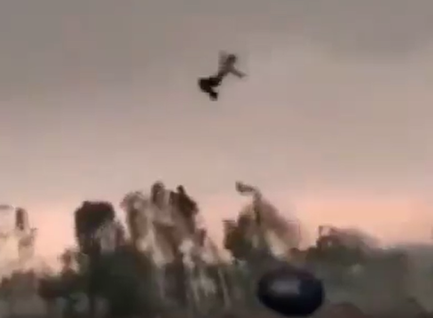 A person being catapulted into the air during a storm.