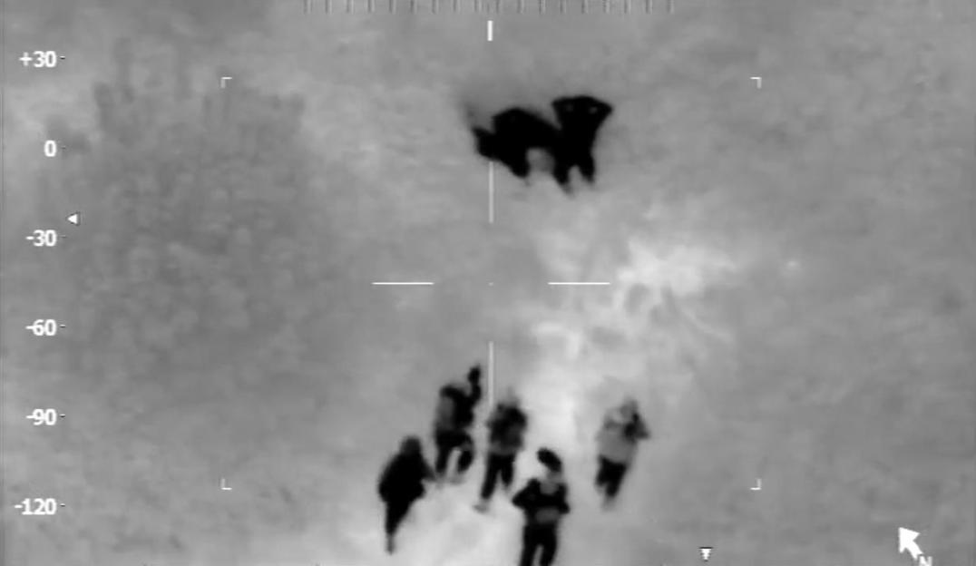 Thermal camera footage from a police helicopter shows armed police officers approaching Geraint Berry and Steven Thomas, who are taking cover in undergrowth.