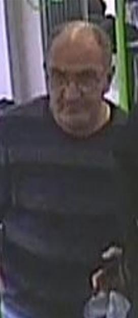 CCTV image of a man with glasses and receding hair, wearing a dark sweater.