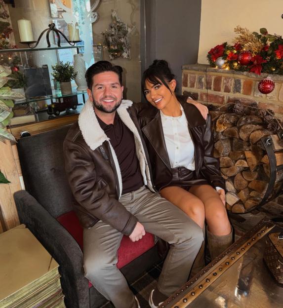 A couple sitting together, celebrating their first Christmas in their new home.