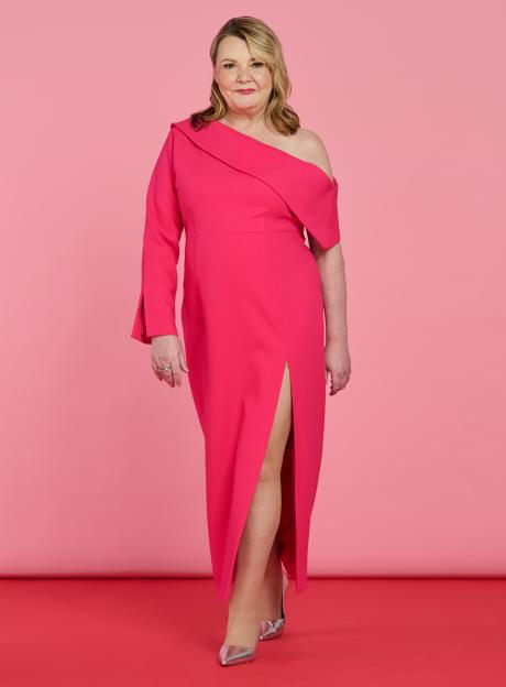 Woman in pink dress against pink background.