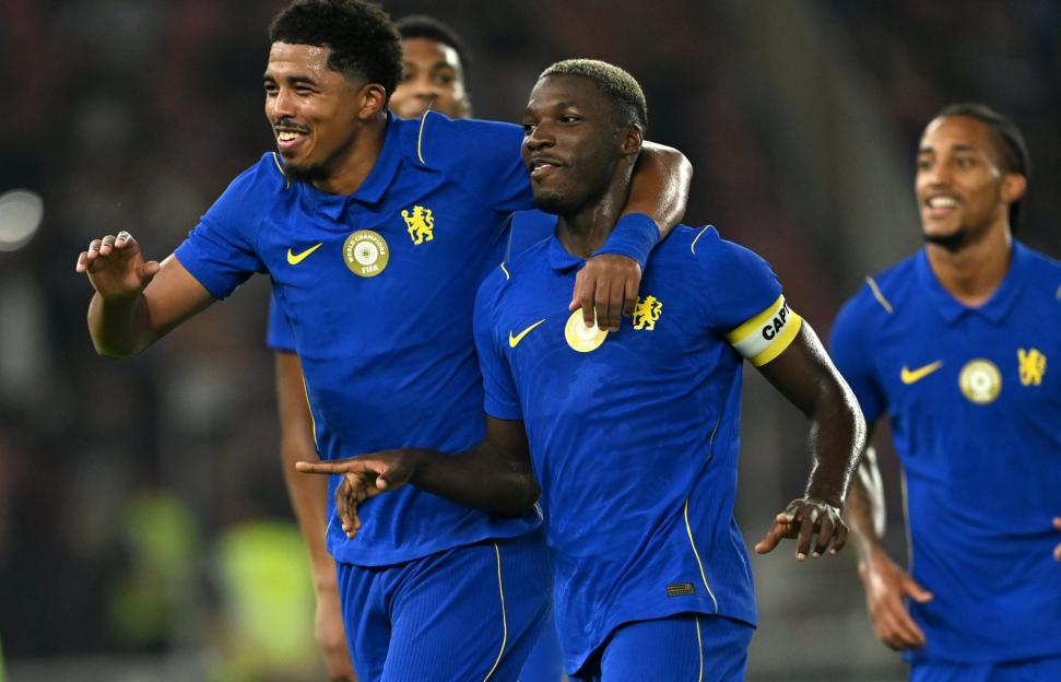 Two Chelsea FC players celebrate, one with his arm around the other.